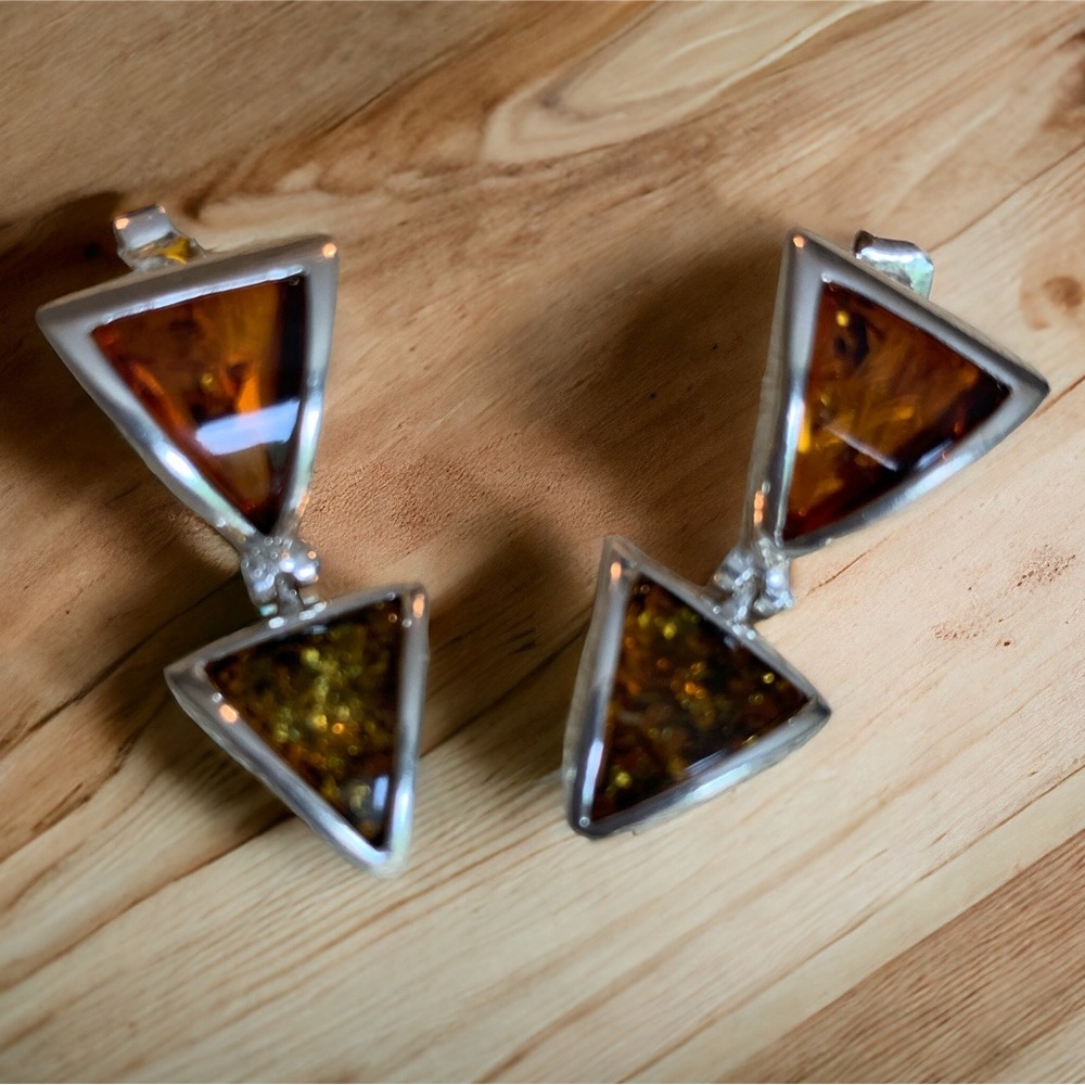 Two tones of amber with inclusions set in sterling silver.